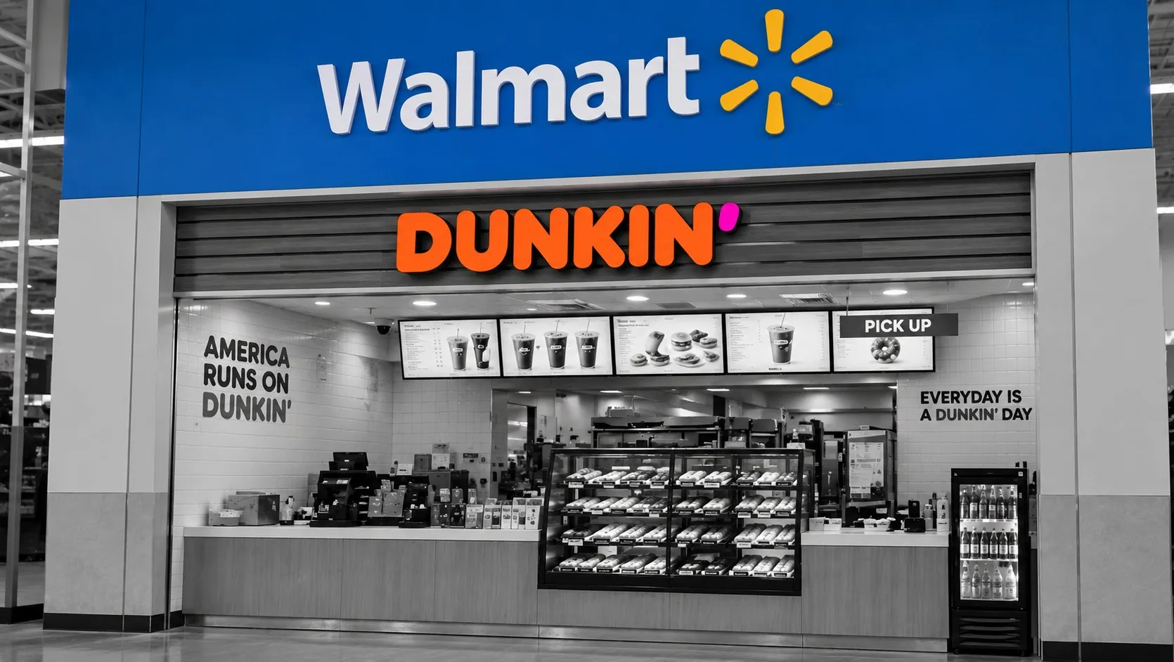A Dunkin' counter built into a Walmart storefront, the blue Walmart sign and orange Dunkin' logo the only color in an otherwise black-and-white scene.